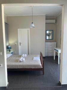 a bedroom with a bed with towels on it at AEGEAN VIEW SEASIDE ROOMS AND STUDIOS KEA in Korissia