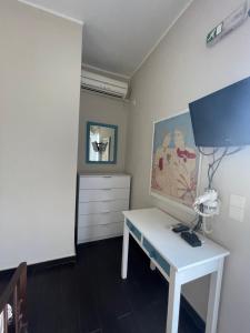 a room with a white desk and a dresser at AEGEAN VIEW SEASIDE ROOMS AND STUDIOS KEA in Korissia