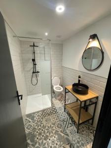 a bathroom with a sink and a toilet at BABILOC Industriel Appartement in Riez