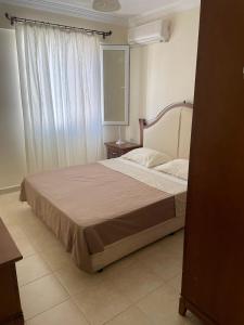 a bedroom with a bed with a large window at Royal Marina in Didim