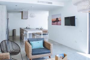 a living room with a chair and a table at Can Romina - Santa Eulalia in Santa Eularia des Riu