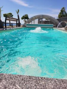 una piscina de agua azul y un puente en Three Stars Luxury House ART-PE with pool and SPA pool, en Trebnje