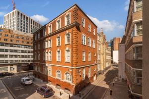 a large brick building in the middle of a city at Studio - Tower Hill - City Centre by Prime London Stays N-5 in London