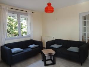 a living room with a couch and a table at Vaste villa en position dominante superbe vue lacs in Hautecour