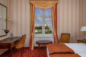 a hotel room with a bed and a window at Ensana Grand Margaret Island in Budapest