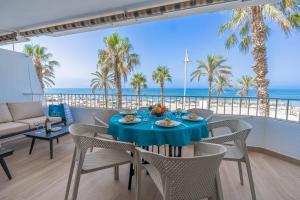 a dining room with a table and chairs and the ocean at Shore Thing Playa in La Herradura
