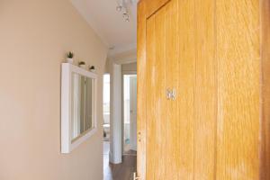 a room with a wooden door and a mirror at Central Dover - 1 Bedroom apartment in Kent