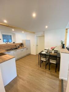 a kitchen with a table and chairs in a room at Fewo Catlen in Traben-Trarbach +8 photos