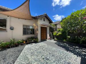 a house with a cobblestone driveway in front of it at Naval bureaucracy in Kaohsiung