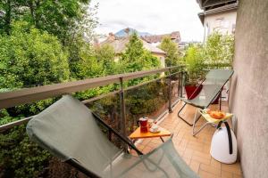 balkon ze stołem i krzesłem na balkonie w obiekcie Cabana & La Parmelante - Proche Lac w Annecy