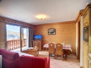 a living room with a table and a dining room at Appartement 3 Pièces à Reberty 2000 - 6 Pers, Piscine, Spa, Parking, Pieds des Pistes - FR-1-178-366 in Les Menuires
