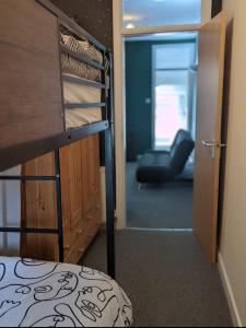 a bedroom with a bunk bed and a door to a gym at 205a Monton Road in Manchester