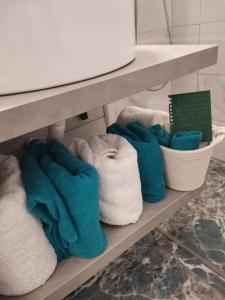 a bunch of towels on a shelf in a bathroom at Bloom Box Apartments in Craiova +36 photos