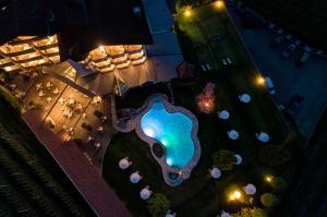an overhead view of a swimming pool at night at Hotel Burggräflerhof in Merano