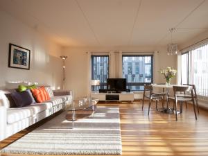 a living room with a couch and a table at BJØRVIKA APARTMENTS, Teaterplassen, Oslo city center in Oslo