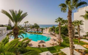 an overhead view of the pool at the resort with palm trees at Royal Azur Thalassa in Hammamet