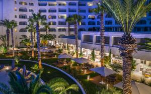 an aerial view of a hotel with palm trees and umbrellas at Royal Azur Thalassa in Hammamet