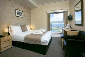 a hotel room with a bed and a window at The Auckland Hotel in Morecambe