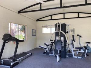 a gym with several tread machines in a room at Rainbow Beach Dream Studio Motel Style Apartment in Rainbow Beach