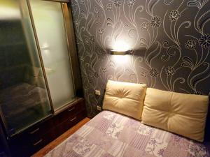 a bedroom with a bed and a wall with a flower pattern at M&M Apartment II SELF CHECK-IN in Panevėžys