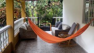 a hammock on the porch of a house at CASA DE CAMPO Villa Ibiza - EXCELENTE DESCANSO in Betulia