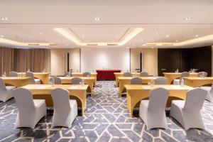 a conference room with tables and chairs and a podium at Best Western Nada Don Mueang Airport hotel in Bangkok +48 photos