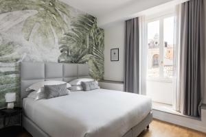 a bedroom with a white bed and a large window at AT FORTY-ONE in Rome