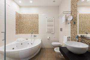 a bathroom with a tub and a toilet and a sink at AT FORTY-ONE in Rome +94 photos