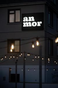 a lit up sign on the side of a building with lights at Bude Hotel - An Mor in Bude