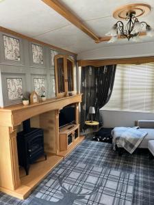 a living room with a bed and a fireplace at 47 Lochview in Stranraer