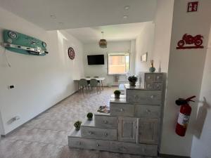 a living room with a dresser and a tv at Casa Vacanze Carmelita Centro-Stazione in Bracciano +10 photos