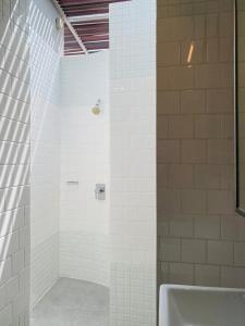 a bathroom with a shower and a bath tub at The Assembly Place, A Co-living at Mayo in Singapore