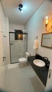 a bathroom with a toilet and a sink and a shower at Gênova 204 Palmas in Governador Celso Ramos
