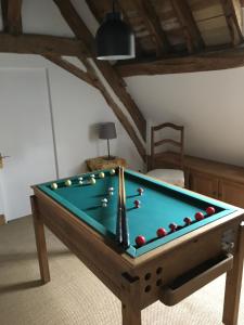 a pool table with balls in a room at Maison de charme Pays de Tronçais in Couleuvre