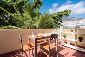 a patio with a table and chairs on a balcony at Best Holiday Fanabe in Adeje
