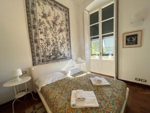 a bedroom with a bed with two towels on it at Cavour in Levanto