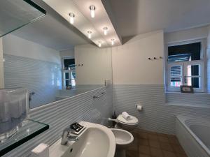 a bathroom with a sink and a toilet and a mirror at Cavour in Levanto