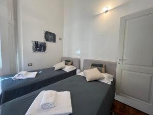 Dos camas en una habitación pequeña con toallas. en Cavour, en Levanto