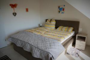 a bedroom with a bed with a striped comforter at Ferienwohnung Mechernich-Eifel in Mechernich