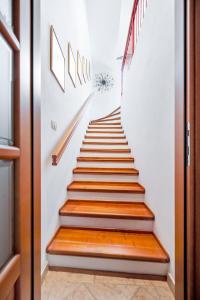a staircase with wooden treads in a house at Apartman Agata in Rovinj