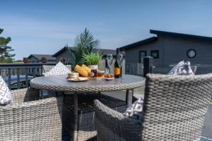 a table and chairs with food on a patio at Number Four - Piran View in Padstow