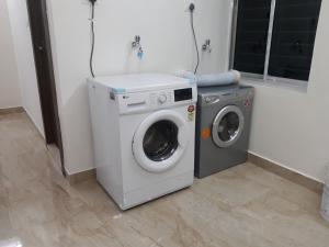 a washing machine and a dryer in a room at City Central Hostel in Kolkata