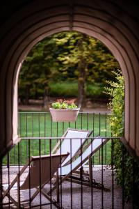 a planter on a railing with a table and a bench at Hotel Mas de Xaxas in Camprodon