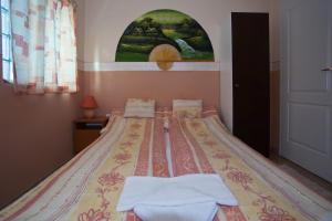 a bedroom with a bed with towels on it at Margaret Apartman in Egerszalók +56 photos