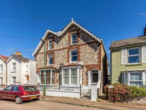 a red car parked in front of a house at Pass the Keys Modern Central Chichester Studio wParking Wi-Fi in Chichester