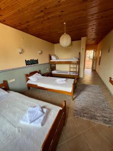 a bedroom with two beds and a wooden ceiling at Datca Villa Carla Hotel in Datca