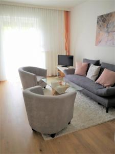 uma sala de estar com um sofá e uma mesa em Ferienwohnungen Kircher Villa Baudisch em Sattendorf