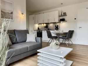 a living room with a couch and a table at Kellenhusen Tor 6 in Kellenhusen