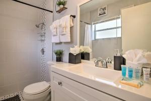a bathroom with a sink and a toilet and a mirror at Lovely Lauderhill Retreat Less Than 12 Mi to Beach! in Lauderhill +21 photos