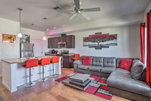 a living room with a couch and a kitchen at Spacious Denver Townhome Near Central Park! in Denver